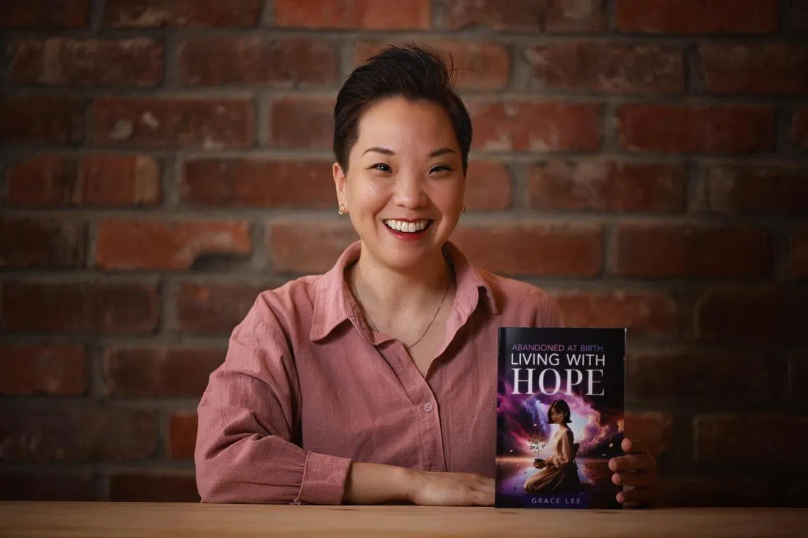 Grace Lee with her book, "Abandoned At Birth, Living With Hope" photographed on Oct 2.