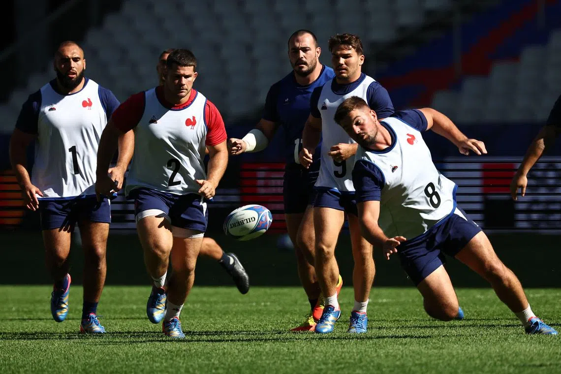 TOPSHOT - France's prop Reda Wardi, France's hooker Julien Marchand, France's scrum-half Antoine Dupont and France's number eight Gregory Alldritt (L to R with white jersey) practice during a training session at the Stade de France in Saint-Denis, near Paris on September 7, 2023, on the eve of the opening match of the Rugby World Cup 2023. (Photo by Anne-Christine POUJOULAT / AFP)