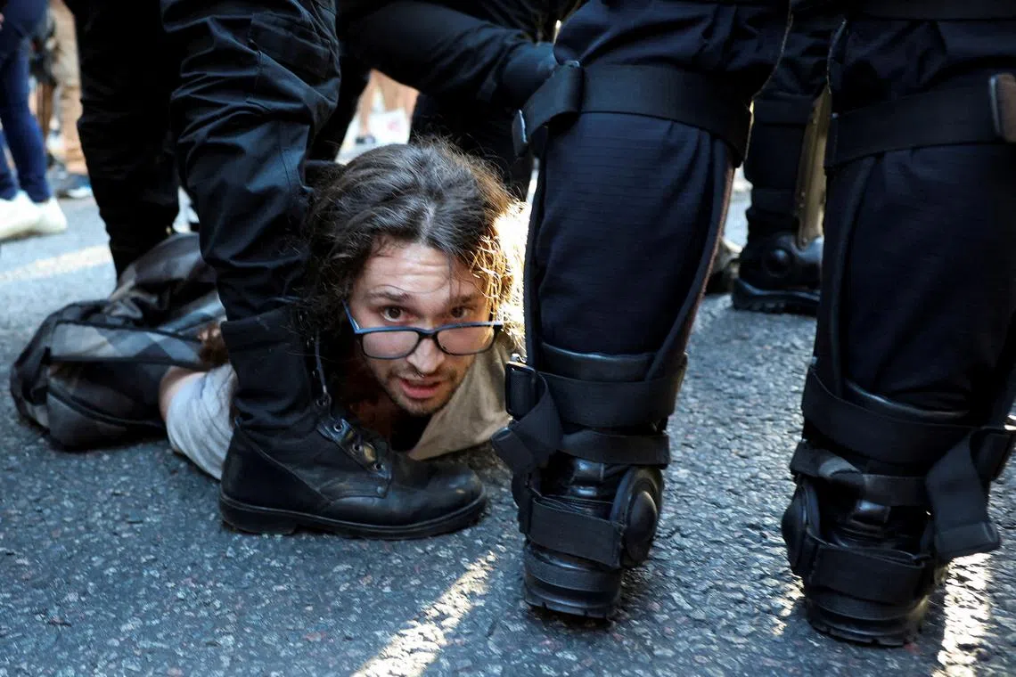 A man is detained during a demonstration against Argentina's President Javier Milei adjustment policies, in Buenos Aires, Argentina, on Feb 19, 2025.
