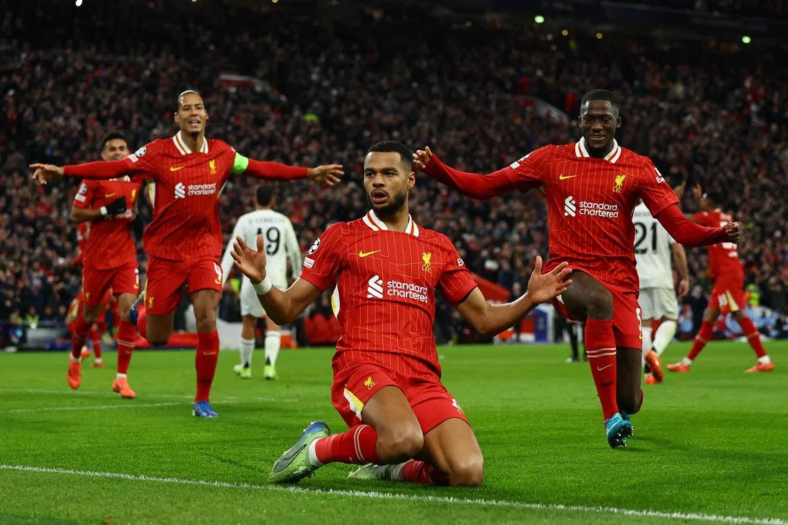 Liverpool's Cody Gakpo celebrates scoring their second goal with Virgil van Dijk and Ibrahima Konate.