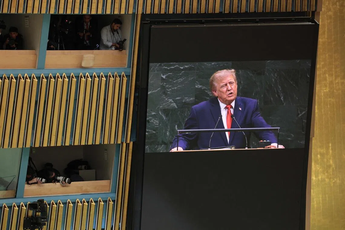 US President Donald Trump is seen on a screen delivering an address to the United Nations General Assembly on Sept 22, in New York City.