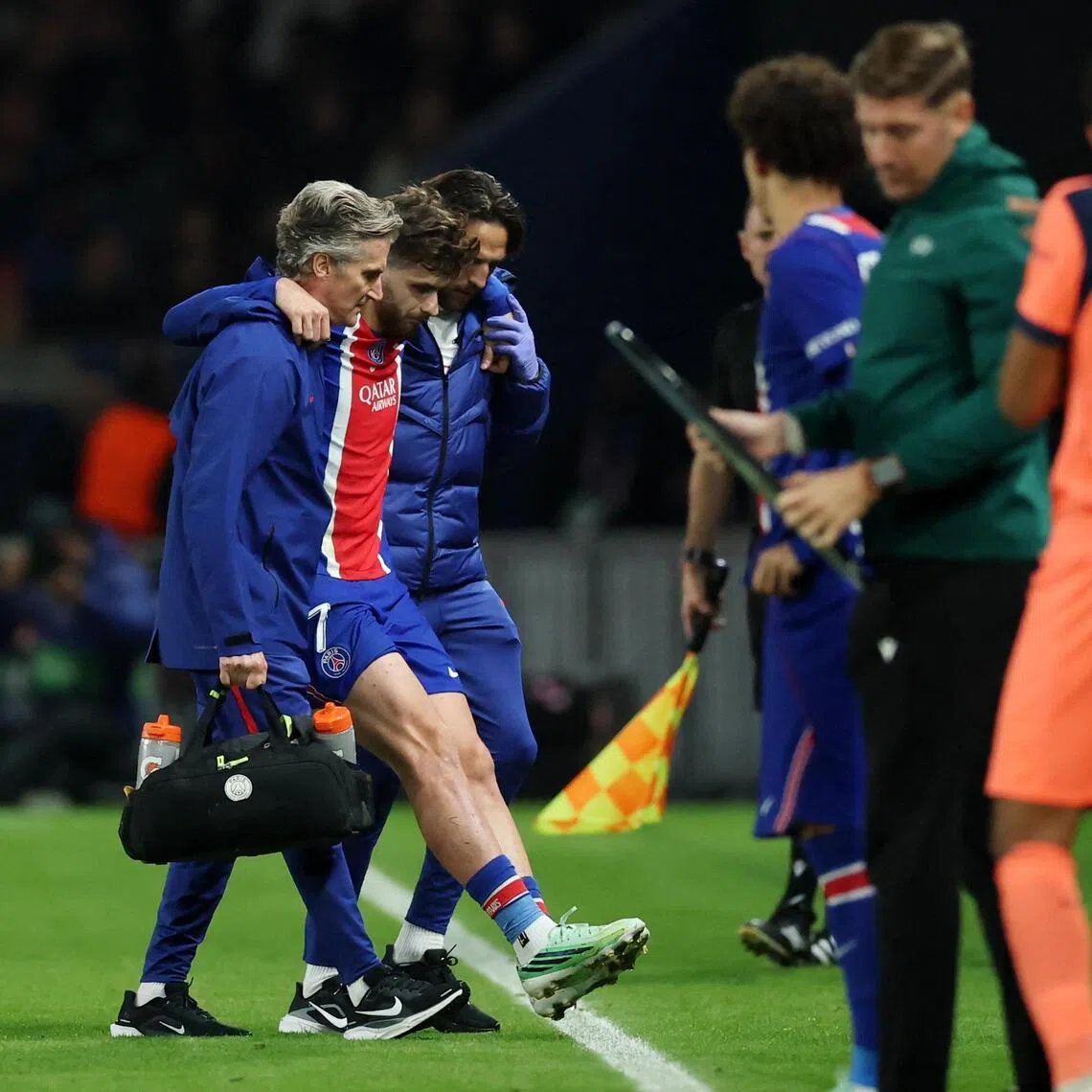 Paris Saint-Germain’s Khvicha Kvaratskhelia leaves the pitch after sustaining an injury during the 4-2 Champions League win over Barcelona.