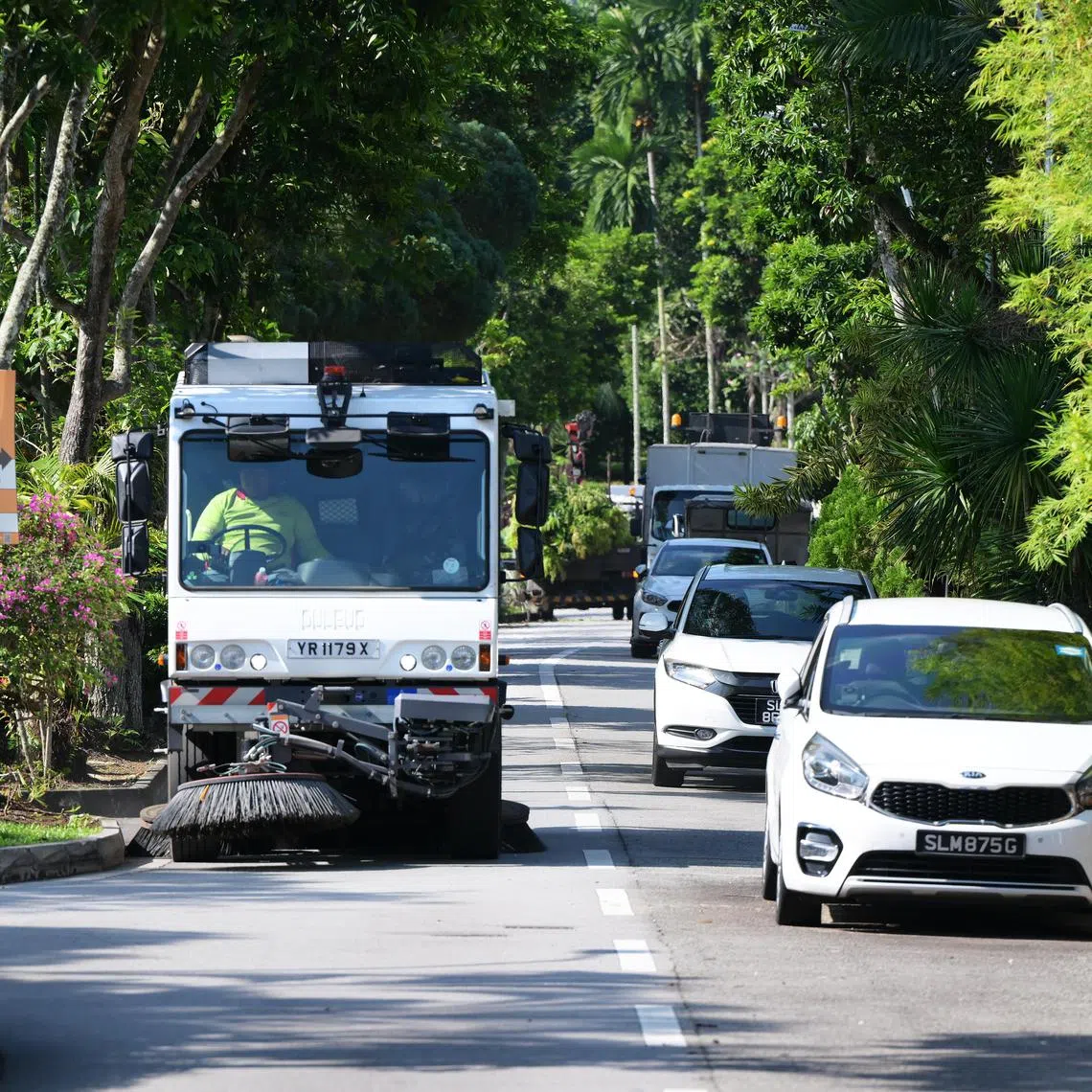 A road sweeping vehicles ploughs Jalan Wajek, a roughly 300m-long road in the Jalan Wajek estate in Bukit Timah, as part of the National Environment Agency's Alternate Roadside Parking programme, which was launched in 2019.