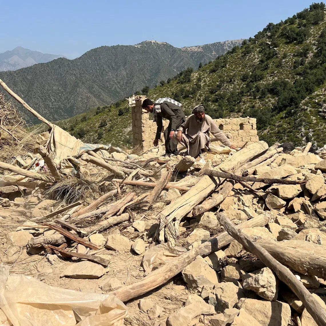 Men salvage their belongings from the debris of a house that was damaged in what the Taliban said was a Pakistani airstrike in Shultan district in Kunar province, Afghanistan, October 1, 2026. REUTERS/Stringer