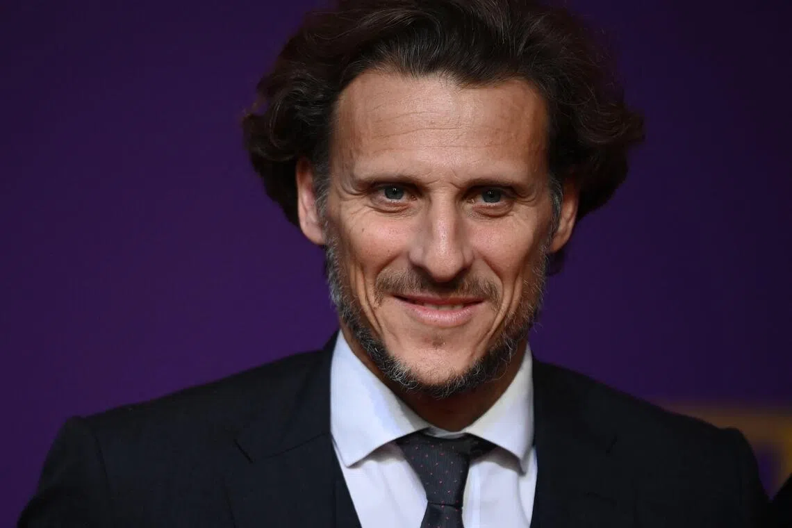 (FILES) Former Uruguayan footballer Diego Forlan arrives for the draw for the 2022 World Cup in Qatar at the Doha Exhibition and Convention Center on April 1, 2022. The Uruguayan Football Association (AUF) is on July 13, 2026, on the verge of finalising an agreement with Diego Forlan for him to take charge of the Under-20s and act as interim manager of the senior team, following its failure at the World Cup with Marcelo Bielsa in charge. The former striker is the third-highest goalscorer in La Celeste’s history, behind Luis Suarez and Edinson Cavani. Winner of the Ballon d’Or in South Africa, the forward was crowned champion of the 2011 Copa America in Argentina, the senior national team’s most recent major achievement. (Photo by FRANCK FIFE / AFP)