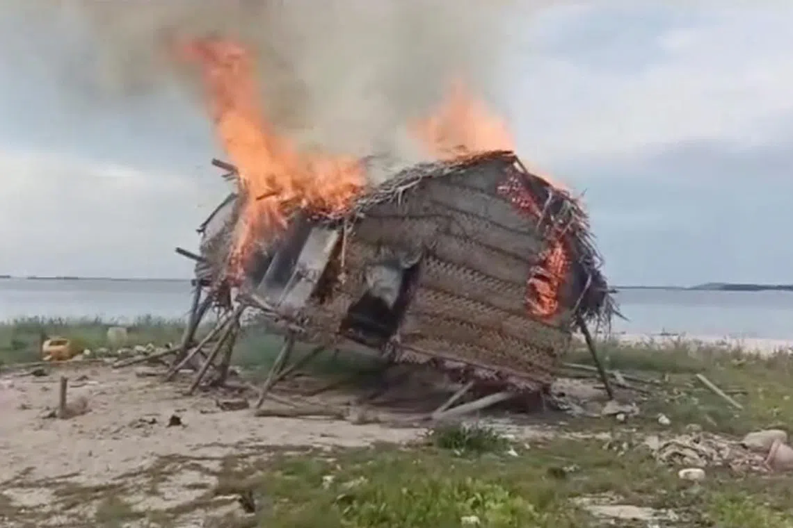 Smoke rises as a house is demolished in Tun Sakaran Marine Park, Sabah, Malaysia, in this screen grab obtained from a social media video, released on June 4, 2024. Video obtained by Reuters/via REUTERS