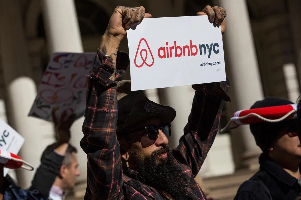 (FILES) Supporters of Airbnb show support for the company during a rally on the steps of New York City Hall in New York City on October 30, 2015. If you've been trying to book an apartment for a short vacation in New York in recent weeks, you may have been surprised at how little is available on platforms like Airbnb or VRBO. A city law went into effect this week that bans rentals for less than 30 days, leaving a good part of the 36,000 short-term tourist apartments in the city out of the rental game. (Photo by Andrew Burton / GETTY IMAGES NORTH AMERICA / AFP)