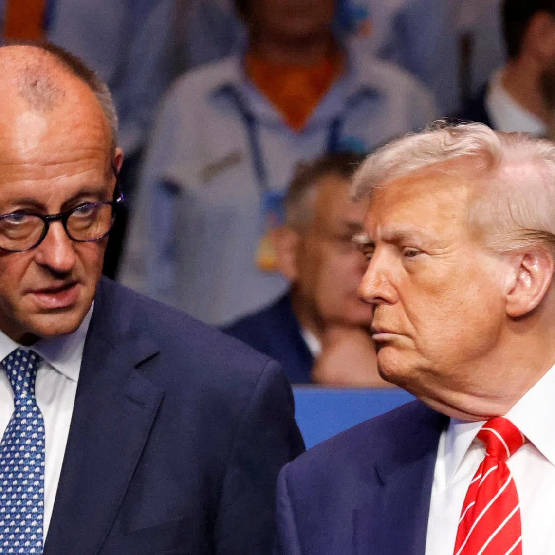 Germany's Chancellor Friedrich Merz speaks with US President Donald Trump before the start of the North Atlantic Council plenary meeting at the North Atlantic Treaty Organisation (NATO) summit in The Hague on June 25, 2025.      LUDOVIC MARIN/Pool via REUTERS/File Photo