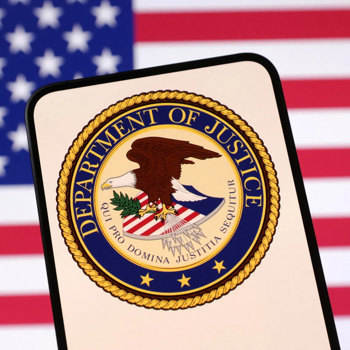 United States Department of Justice logo and U.S. flag are seen in this illustration taken April 23, 2025. REUTERS/Dado Ruvic/Illustration