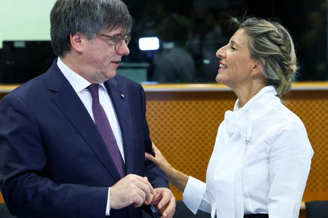 Catalan separatist leader Carles Puigdemont talks with Spanish Deputy Prime Minister Yolanda Diaz, at the European Parliament in Brussels, Belgium September 4, 2023. REUTERS/Yves Herman