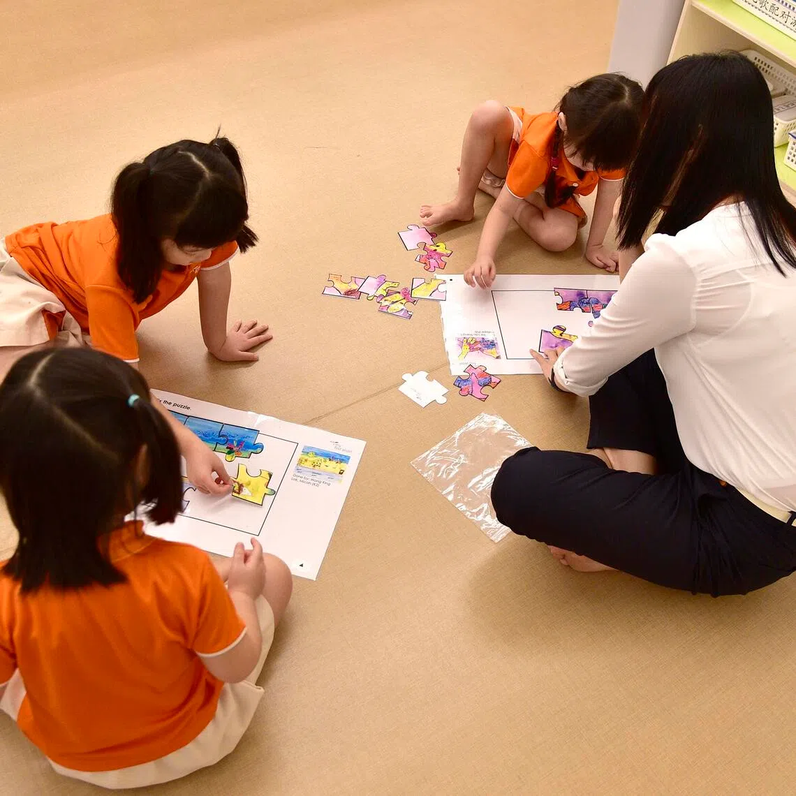 Preschoolers from NTUC My First Skool engaging in a jigsaw puzzle activity on 5 May 2017.