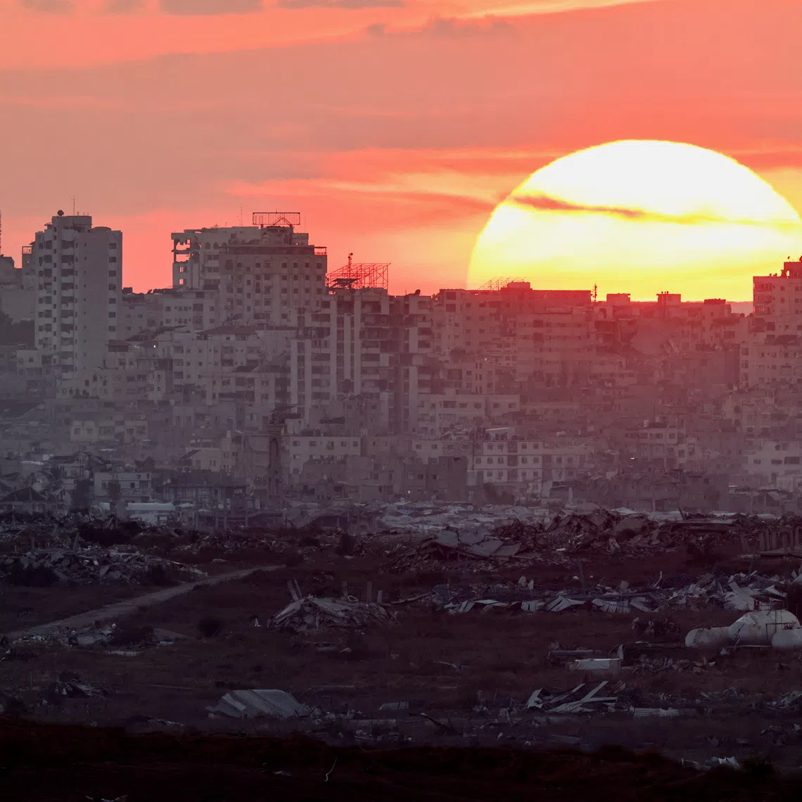 The sun sets over Gaza, as seen from the Israeli side of the border, September 23, 2026. REUTERS/Amir Cohen