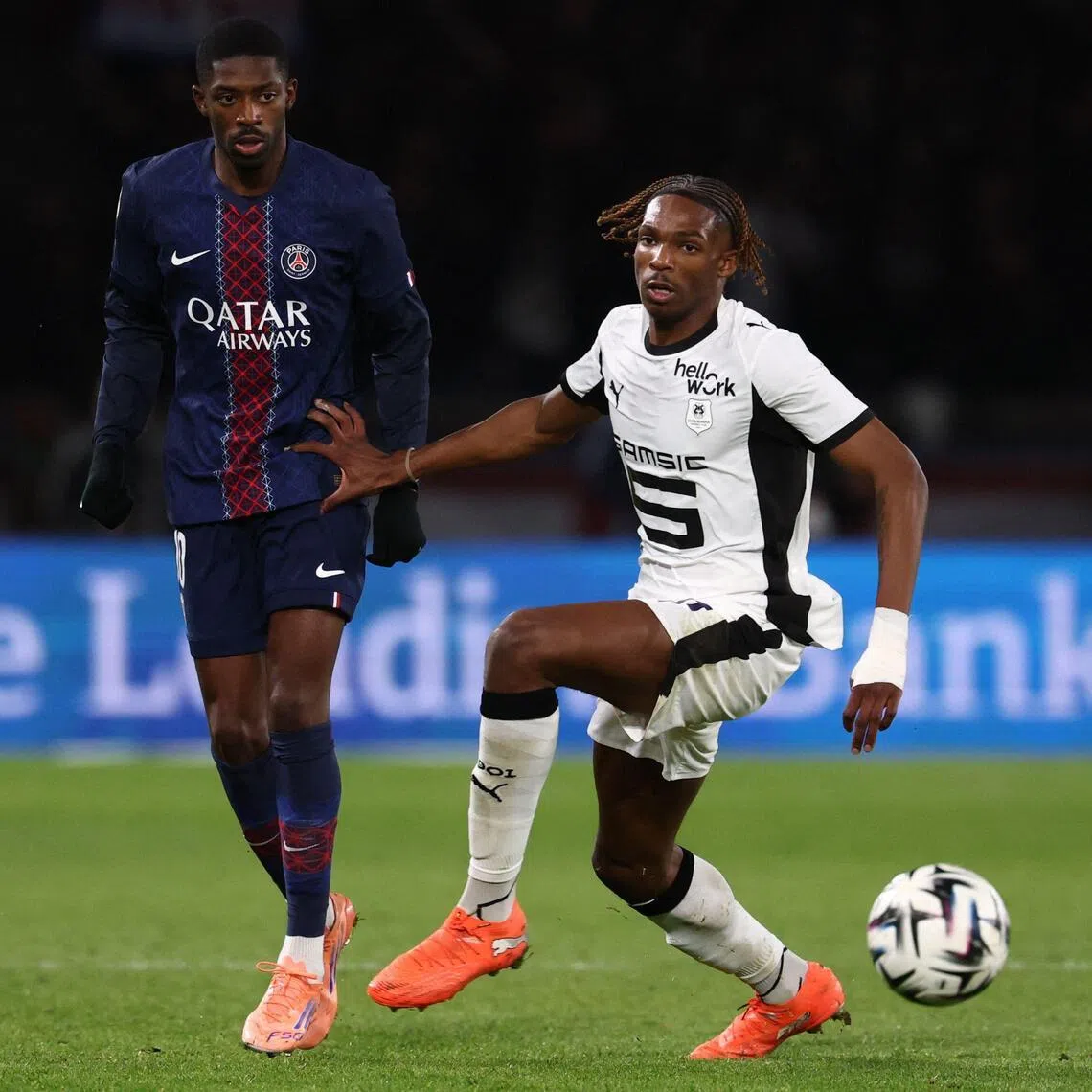 Paris Saint-Germain's French forward Ousmane Dembele (left) and Rennes' French defender Jeremy Jacquet fighting for the ball during a Ligue 1 football match at the Parc des Princes stadium in Paris on Dec 6, 2025. Jacquet looks set to join Liverpool.