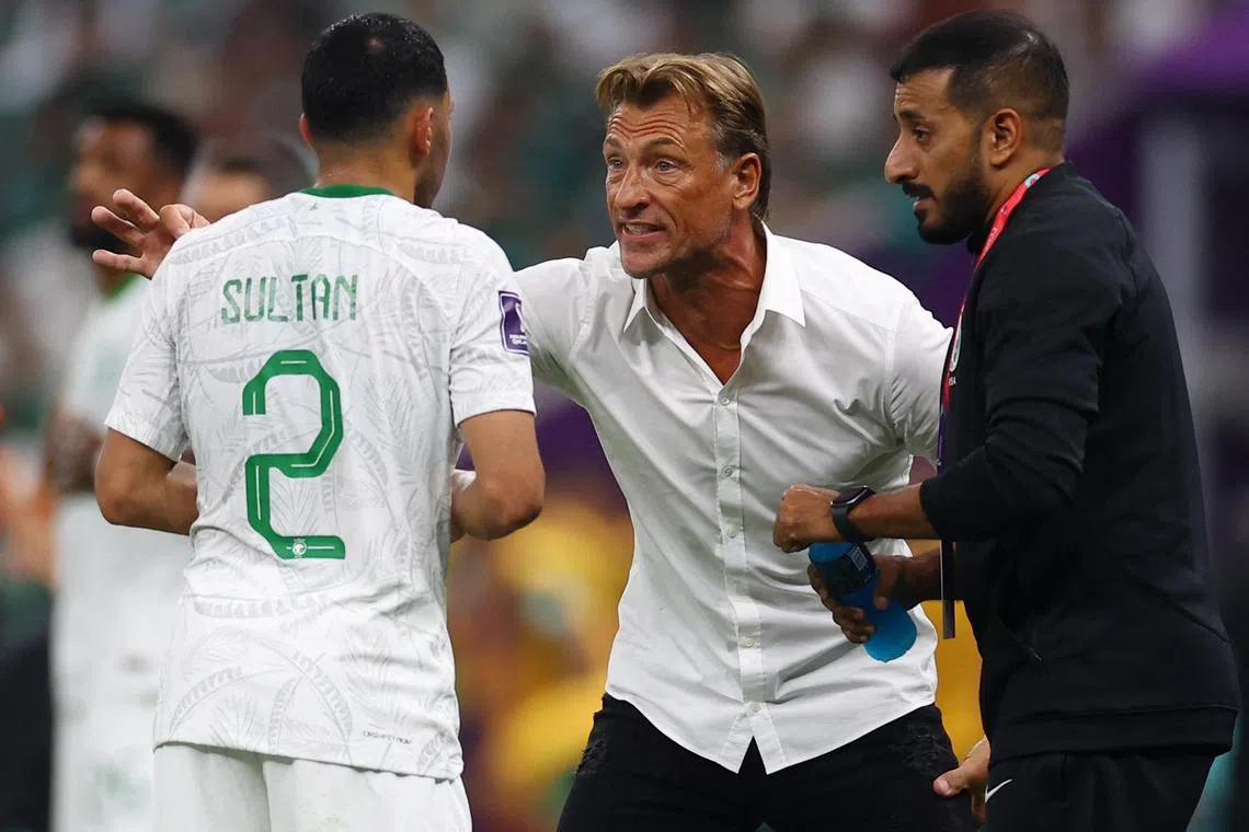 Saudi Arabia coach Herve Renard (centre) speaking to Sultan Al Ghannam (left) during Wednesday's game against Mexico. 