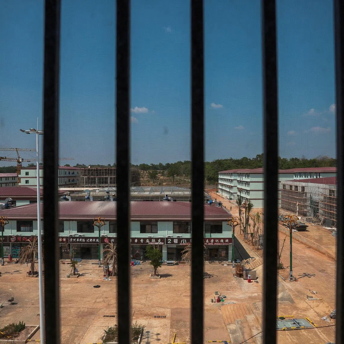 FILE PHOTO: A compound in O'Smach used for scam operations is seen through barred windows from inside the compound, at the Chong Chom-O'Smach border crossing, which was bombed and occupied by the Thai military in December following clashes between Thailand and Cambodia along a disputed border area, in Samraong, Oddar Meanchey province, Cambodia, April 7, 2026. REUTERS/Chalinee Thirasupa/File Photo