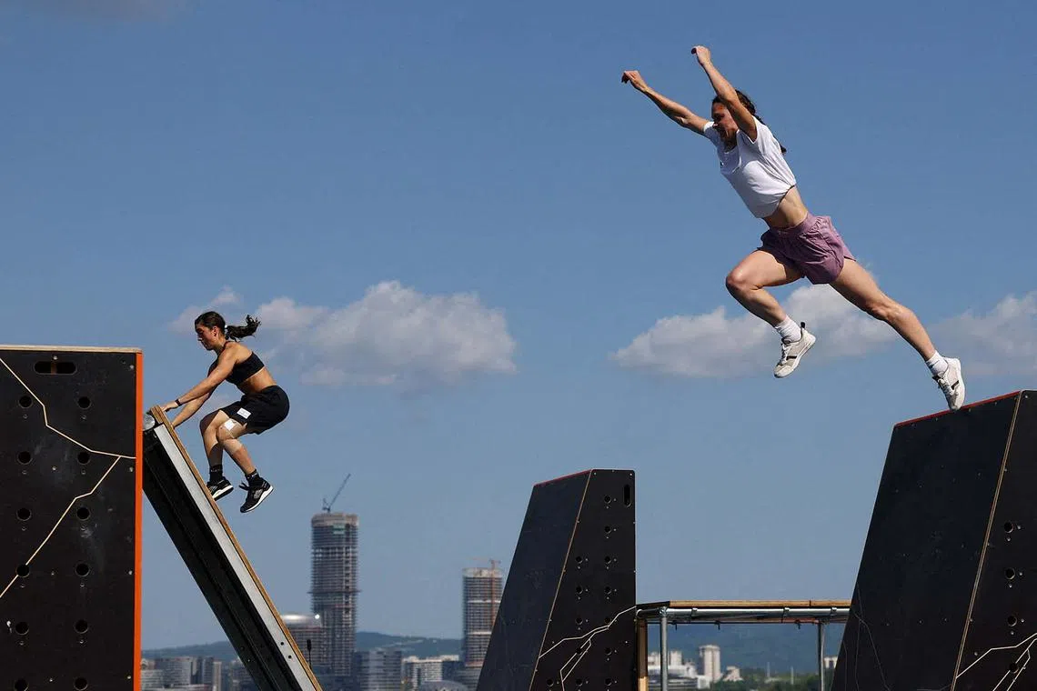 The World Games Chengdu 2025 - Parkour - Xinglong Lake Hubin Arena - Chengdu, China - August 12, 2025 Bulgaria's Kseniya Momchilova and Argentina's Sara Banchoff Tzancoff in action during the women's speed qualification run 1 REUTERS/Lisi Niesner TPX IMAGES OF THE DAY
