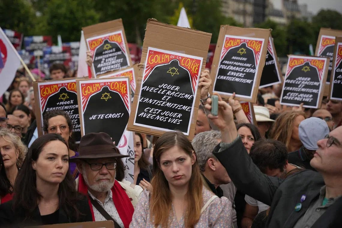 Protesters holding banners that say, "Playing with racism and anti-Semitism is playing with our lives",  during a demonstration in Paris on June 20.