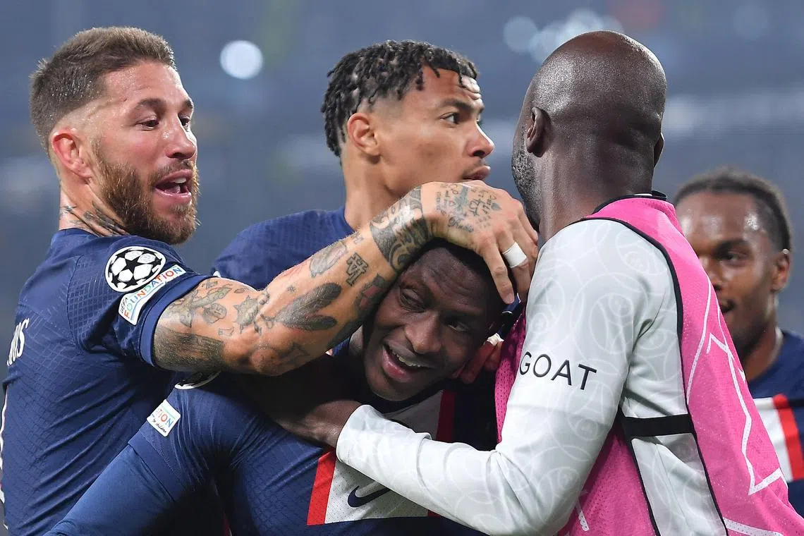 Nuno Mendes celebrates with his teammates after putting PSG in front.