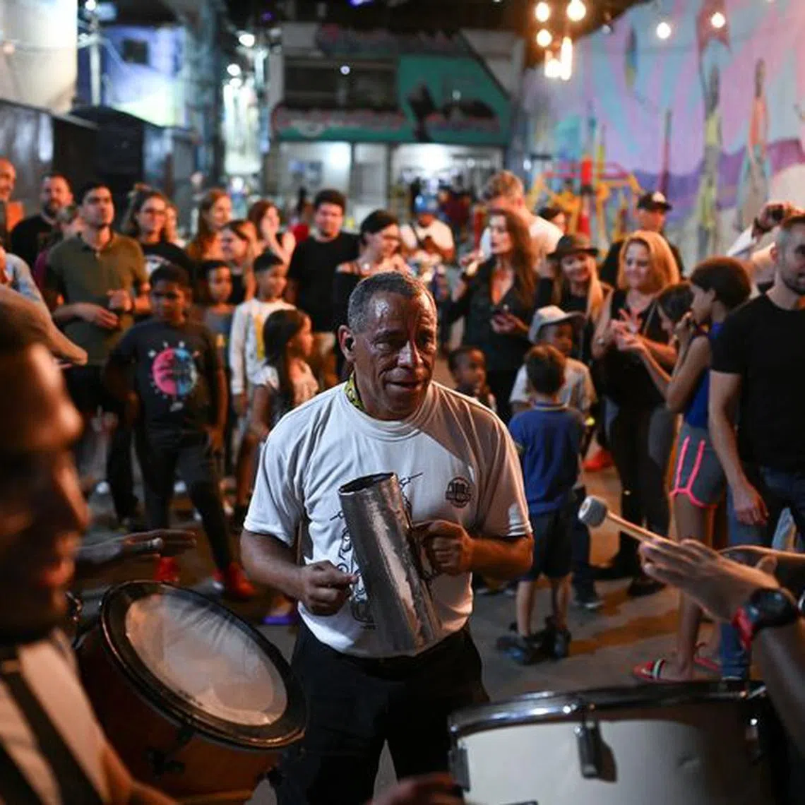 Men play traditional Venezuelan music during an eight-hour tour where customers visit different bars and restaurants in a bid to boost low sales amid the country's persistent inflation, in Caracas, Venezuela December 30, 2023. REUTERS/Gaby Oraa