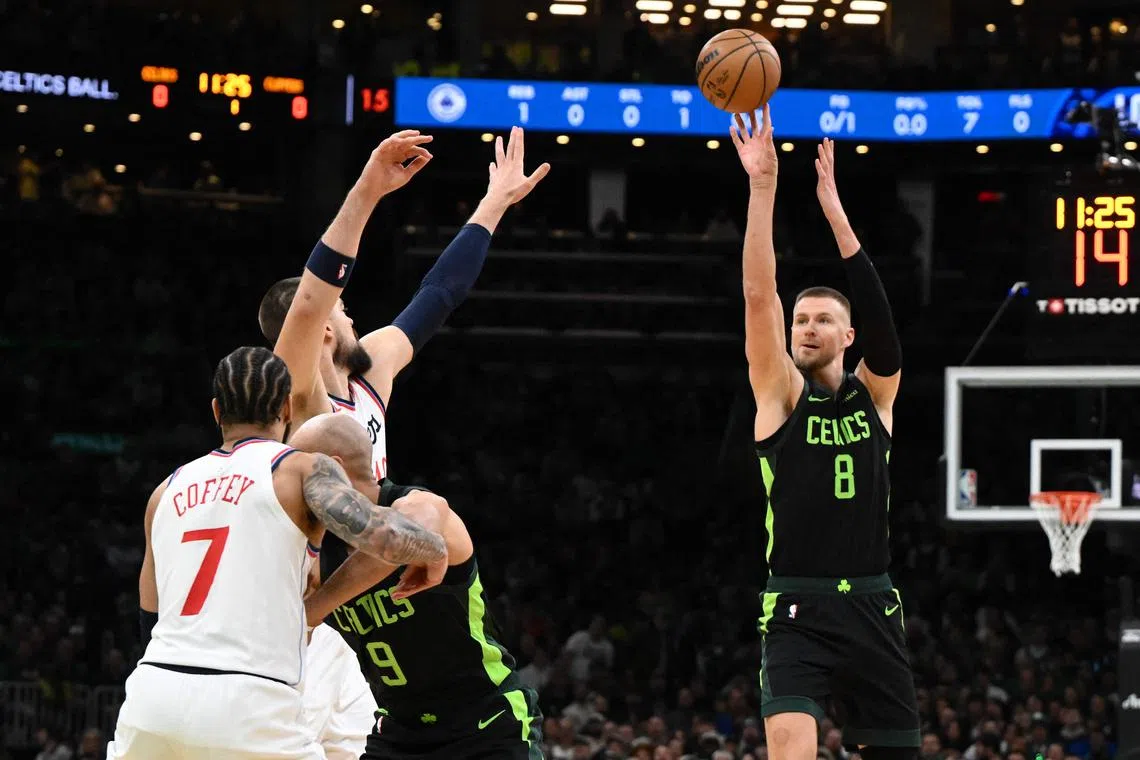 Kristaps Porzingis of the Boston Celtics attempts a three-point basket against the LA Clippers during the first quarter at the TD Garden.
