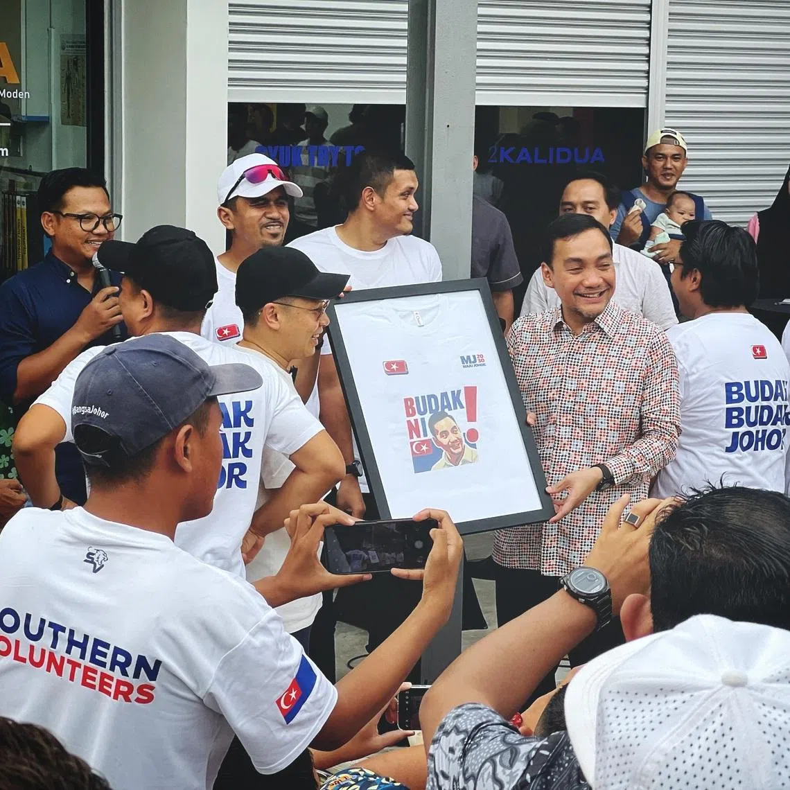 Onn Hafiz Ghazi (wearing batik) incorporates a remark denigrating him as a “budak”, or a kid, into his political campaign.