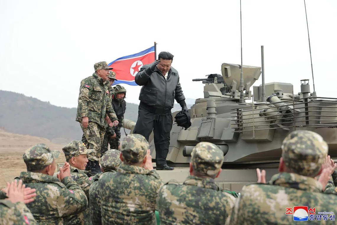 A photo released by the official North Korean Central News Agency shows North Korean leader Kim Jong Un reacting during a training competition involving tank units of the Korean People's Army (KPA) on March 13. 