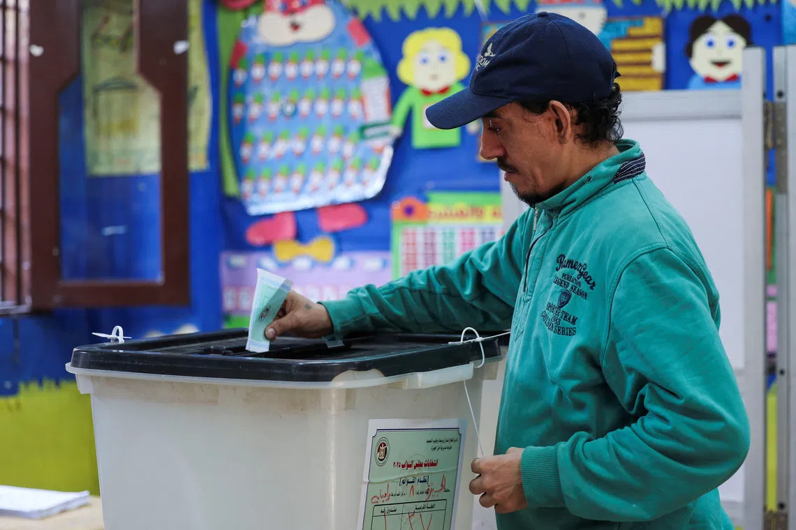 A man votes at a school used as a polling station, during the first round of Egypt's parliamentary elections, in Giza, Egypt, November 10, 2025. REUTERS/Mohamed Abd El Ghany