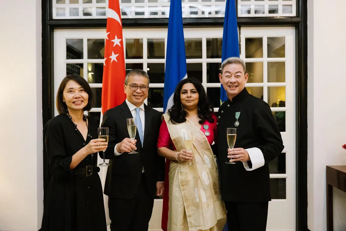 Poet Pooja Nansi (third from left) and theatremaker Ivan Heng (right) were conferred the Knight of the Order of Arts and Letters on June 27.