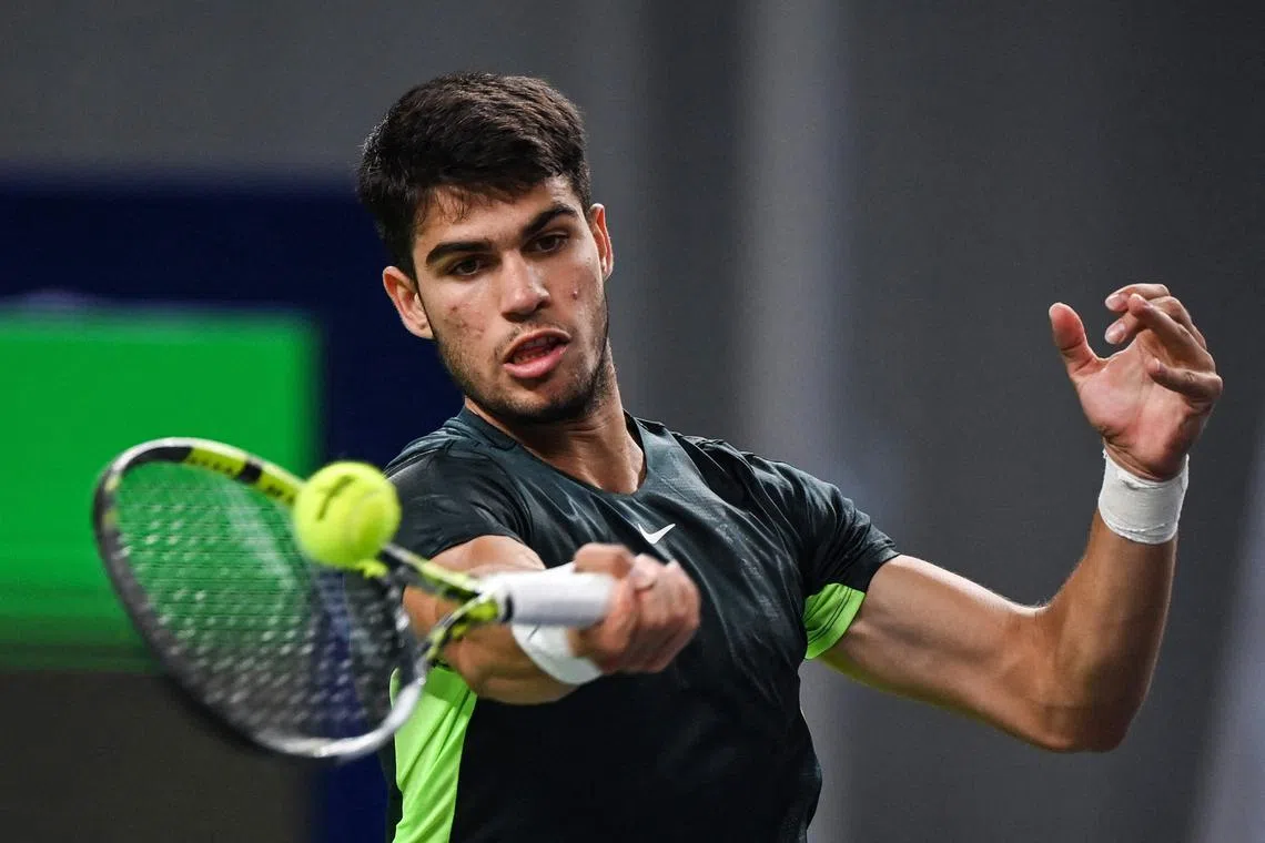 Spain's Carlos Alcaraz hits a return to Gregoire Barrere of France.