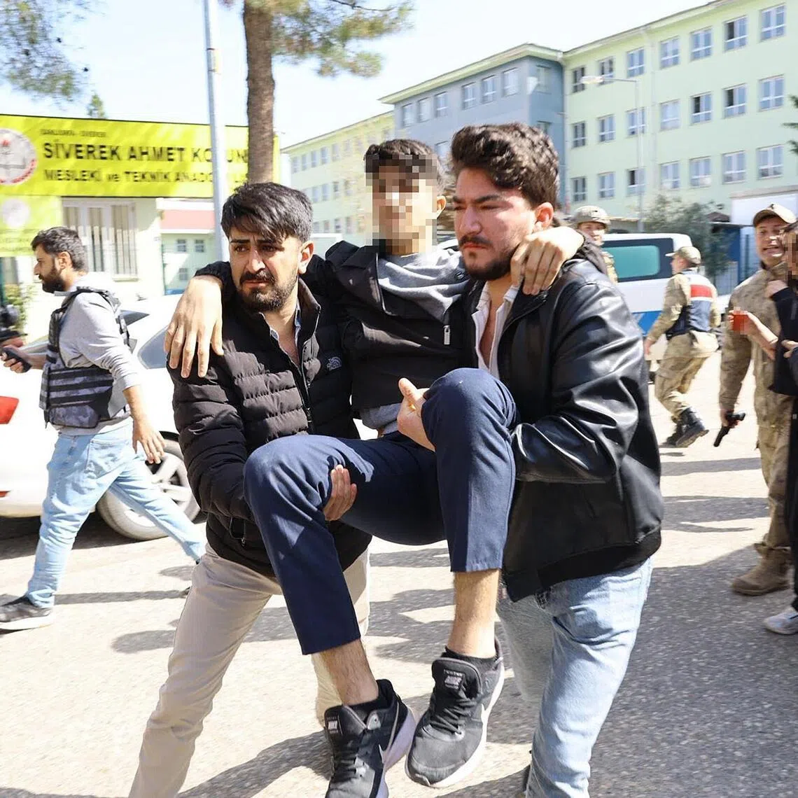 An injured student evacuated as special force security surround the school in south-eastern Turkey on April 14, 2026.