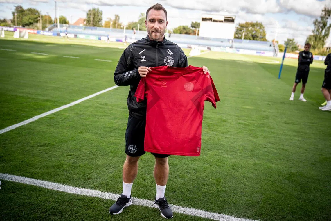 Denmark midfielder Christian Eriksen wearing a black jersey and presenting the team's new red home jersey ahead of the upcoming 2022 World Cup in Qatar. Denmark will wear a "toned down" kit at this year's World Cup in protest at Qatar's human rights record, sportswear maker Hummel said on Sept 28.