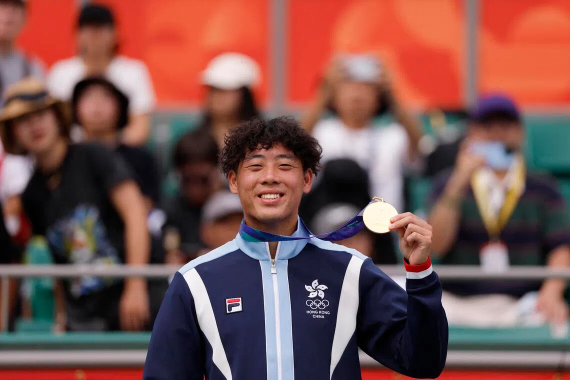 Gold medallist Coleman Wong of Hong Kong poses on the podium during the men’s singles medal ceremony on Oct 3.