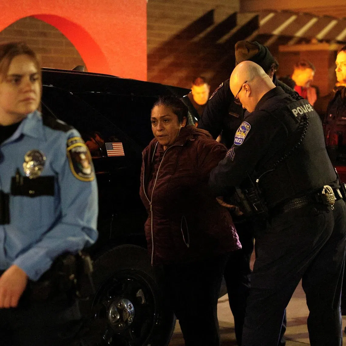 Local police detain a protester against U.S. Immigration and Customs Enforcement (ICE) outside a Target store in Richfield, Minnesota, U.S. February 11, 2026.  REUTERS/Go Nakamura