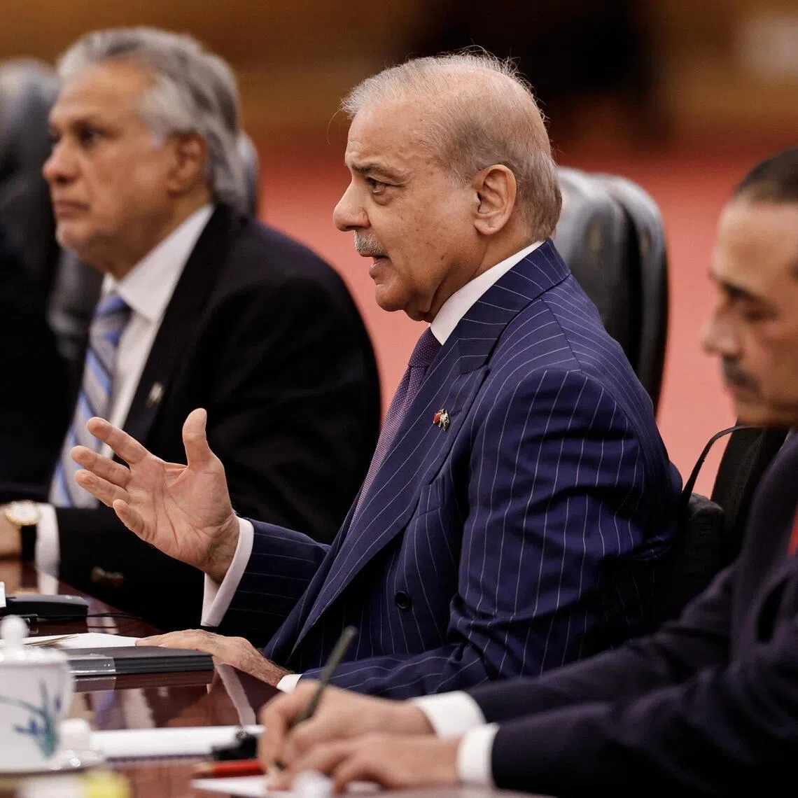 Pakistan's Prime Minister Shehbaz Sharif (centre) announced the deal on X. 