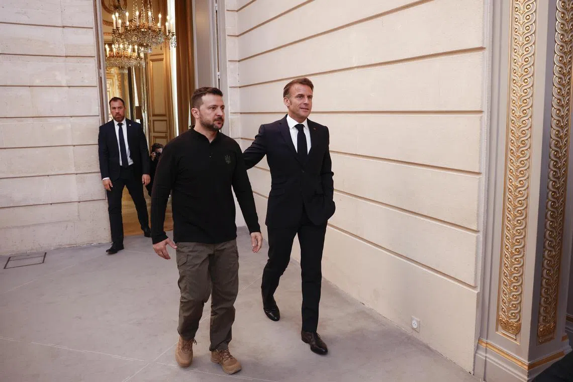 Ukrainian President Volodymyr Zelensky (left) and French President Emmanuel Macron arriving to hold a press conference at the Elysee Palace in Paris, on June 7.
