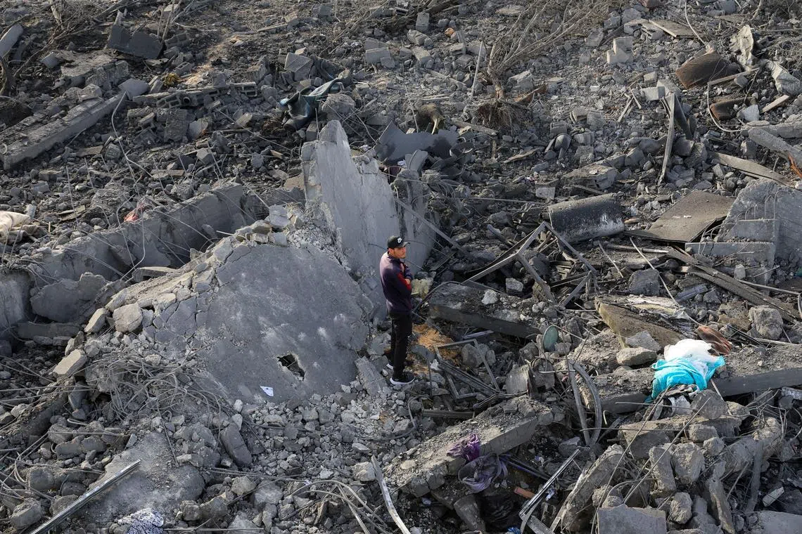 A man stands at the site of an Israeli strike on a house, in Khan Younis, in the southern Gaza Strip, May 15, 2025. REUTERS/Hatem Khaled