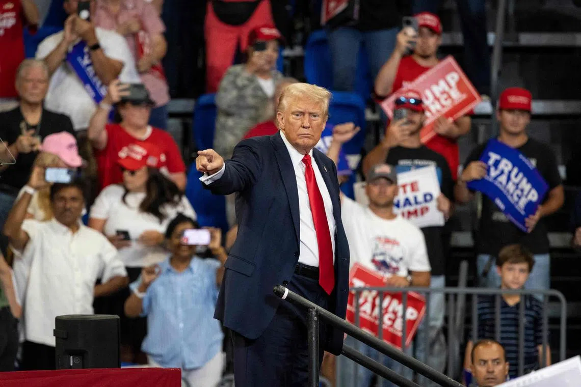 Former US President and 2024 Republican presidential candidate Donald Trump points to the crowd as he leaves after speaking during a campaign rally at the Georgia State University Convocation Center in Atlanta, Georgia, on August 3, 2024. (Photo by CHRISTIAN MONTERROSA / AFP)