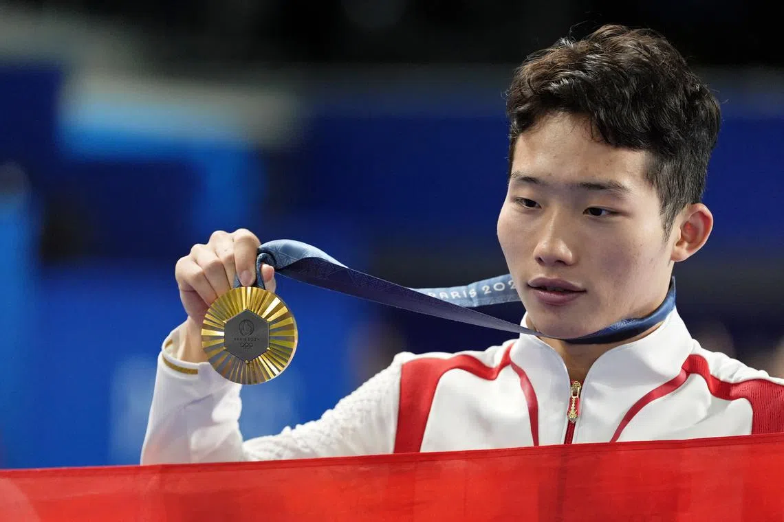 Aug 2, 2024; Paris, France; Zongyuan Wang (CHN) reacts after winning gold in the men’s synchronized 3m springboard finals during the Paris 2024 Olympic Summer Games at Aquatics Centre. Mandatory Credit: Katie Goodale-USA TODAY Sports