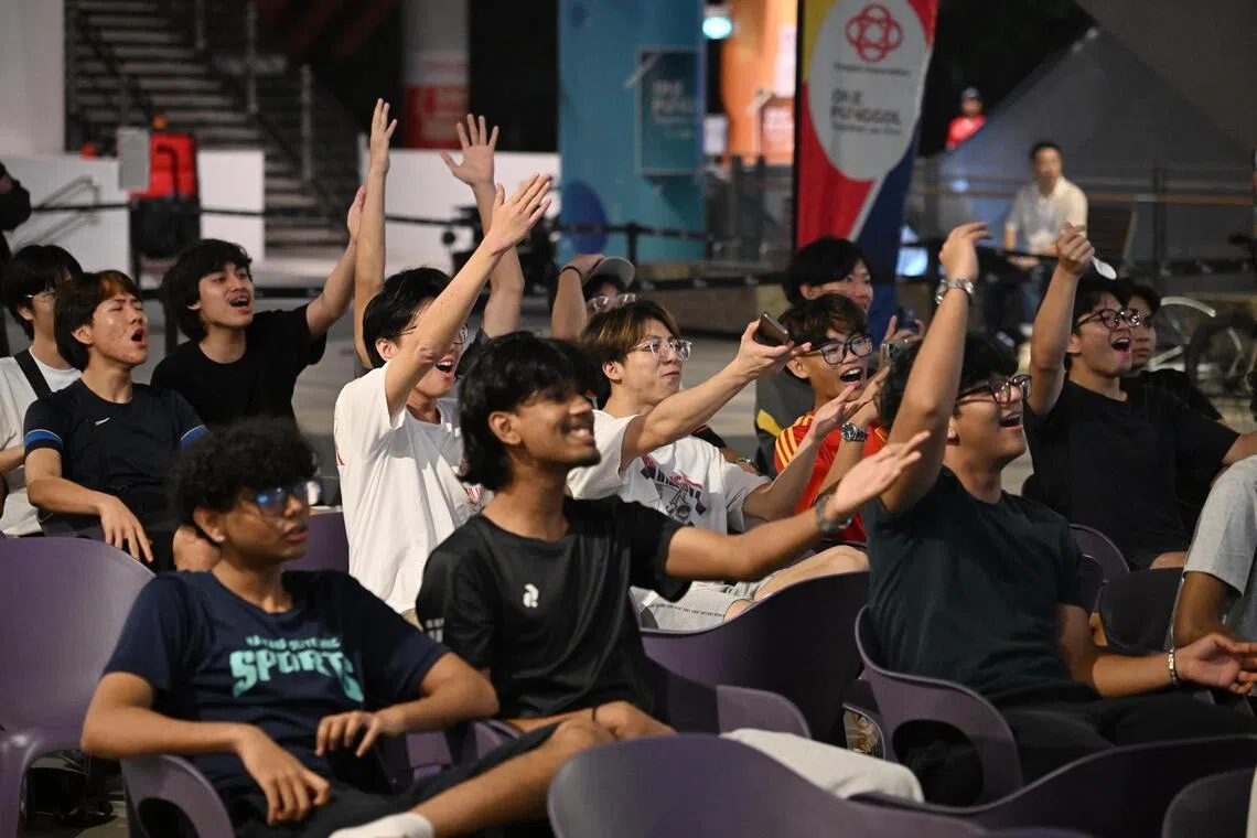 Fans watching the live screening of the World Cup opener at One Punggol on June 12.