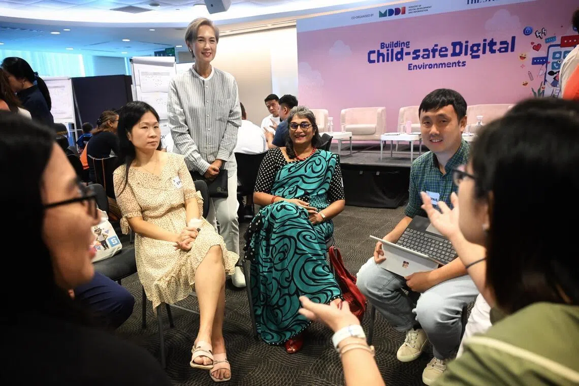 Minister for Digital Development and Information Josephine Teo observing the small group discussion on July 25.