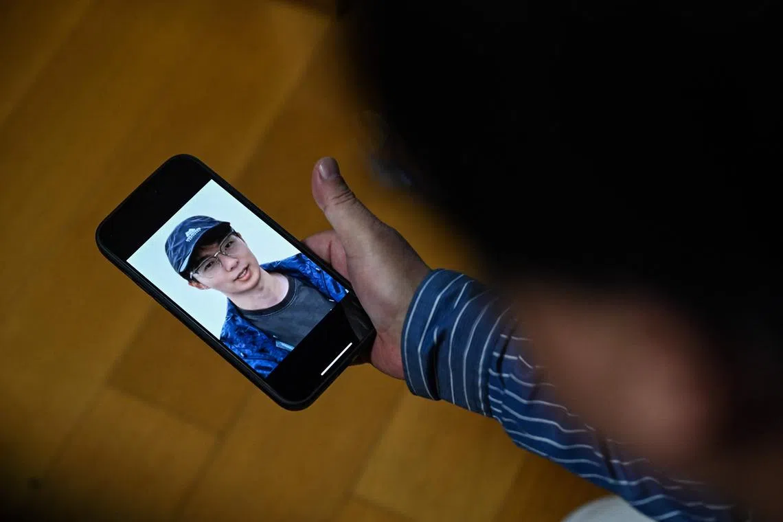 Mr Seakoo Wu watching a video created with AI showing the face and voice of his son, who died last year aged 22.