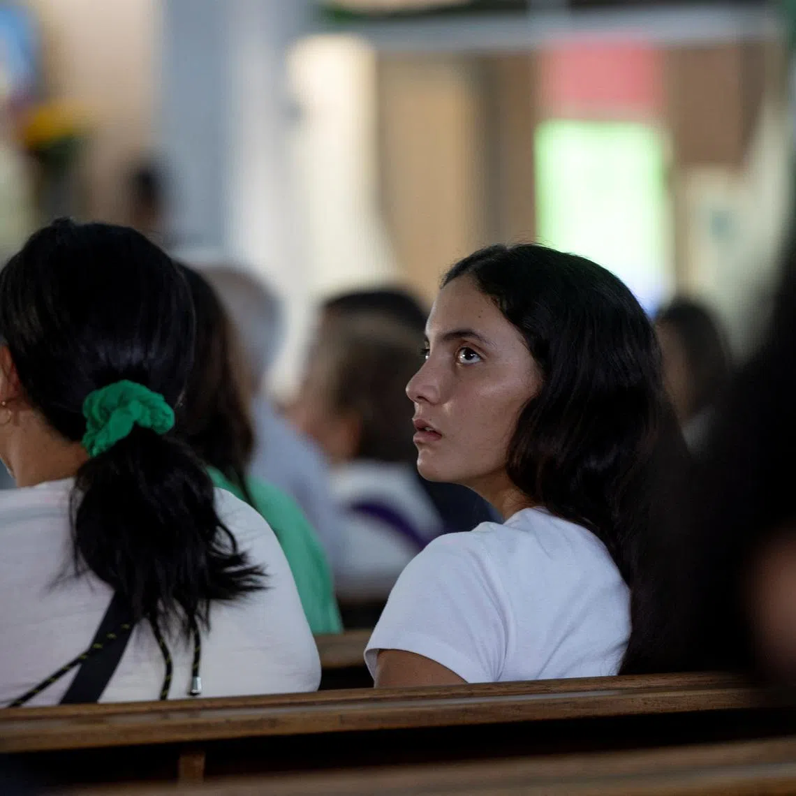 Maria Alejandra Sanz, who survived after spending 17 hours trapped beneath the rubble of her collapsed apartment building following twin earthquakes in La Guaira, attends a memorial service for one of her friends at Iglesia Maria Auxiliadora in Caracas, Venezuela, July 7, 2026. REUTERS/Ricardo Arduengo