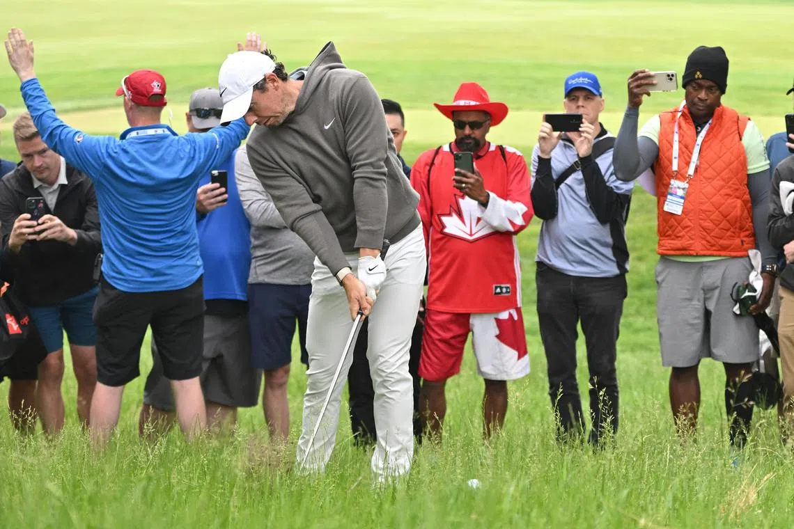Rory McIlroy plays a shot from deep rough during the first round of the Canadian Open.