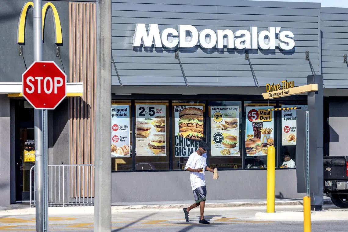 A person leaving a McDonald's restaurant in Miami, Florida, on Oct 23. An E. coli outbreak linked to McDonald's Quarter Pounder burgers affected nearly 50 individuals across 10 US states.