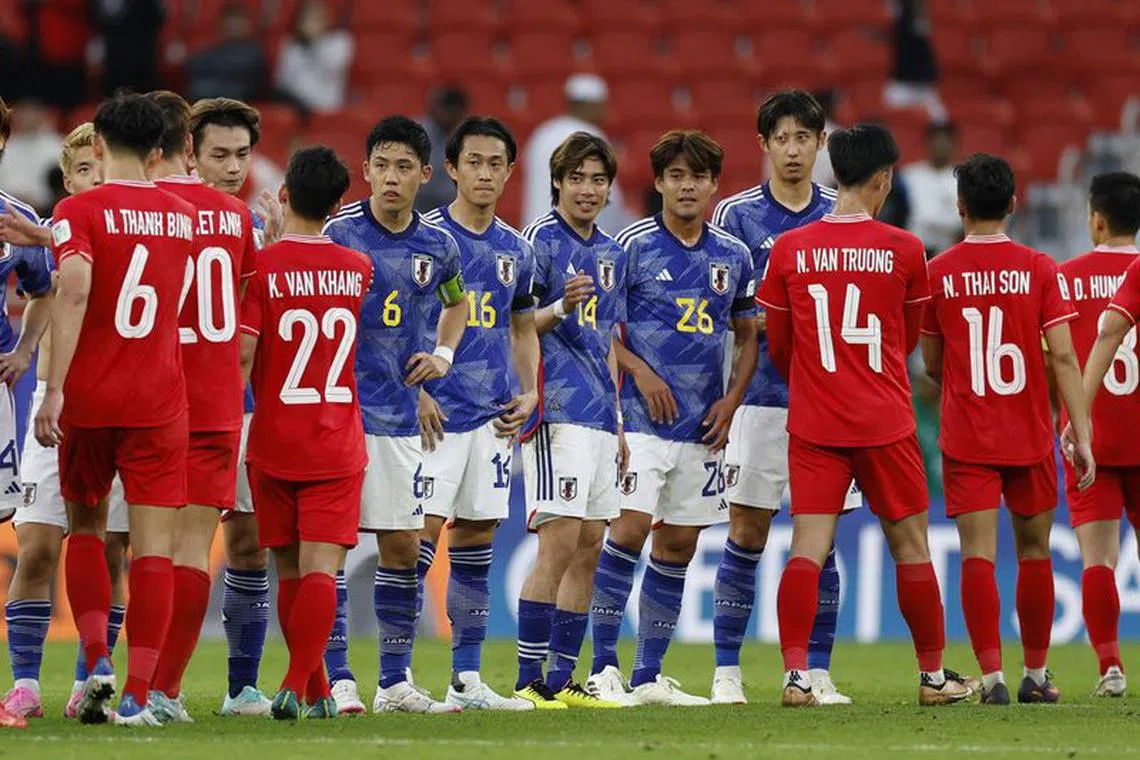 Soccer Football - AFC Asian Cup - Group D - Japan v Vietnam - Al Thumama Stadium, Doha, Qatar - January 14, 2024 General view as players from both teams shake hands after the match REUTERS/Thaier Al-Sudani