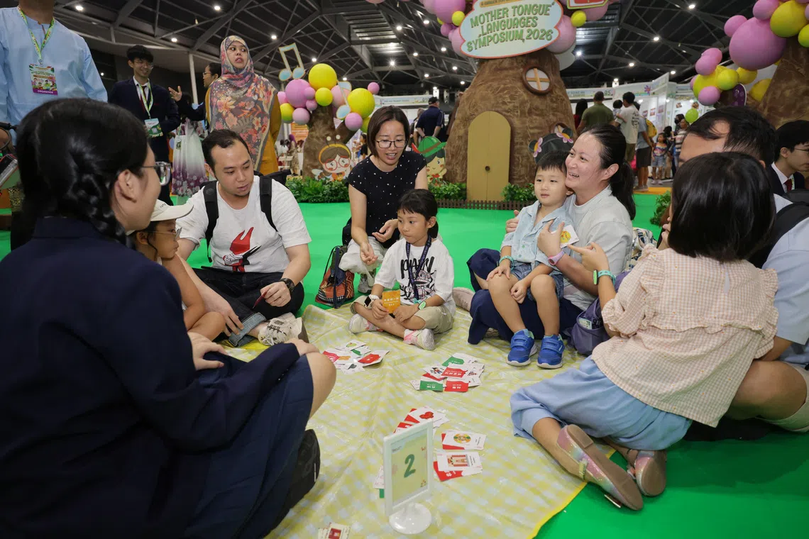 Attendees engaging in activities at the exhibition booths during the 14th Mother Tongue Languages Symposium at Expo on Aug 1.