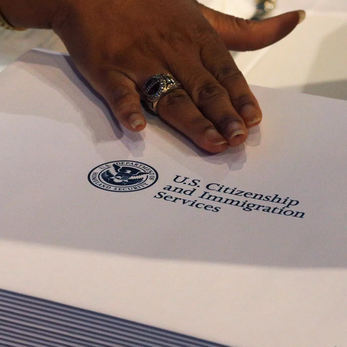 FILE PHOTO: Information packs are distributed by the U.S. Citizenship and Immigration Services following a citizenship ceremony at the John F. Kennedy Presidential Library in Boston, Massachusetts, U.S., July 18, 2018.   REUTERS/Brian Snyder/File Photo