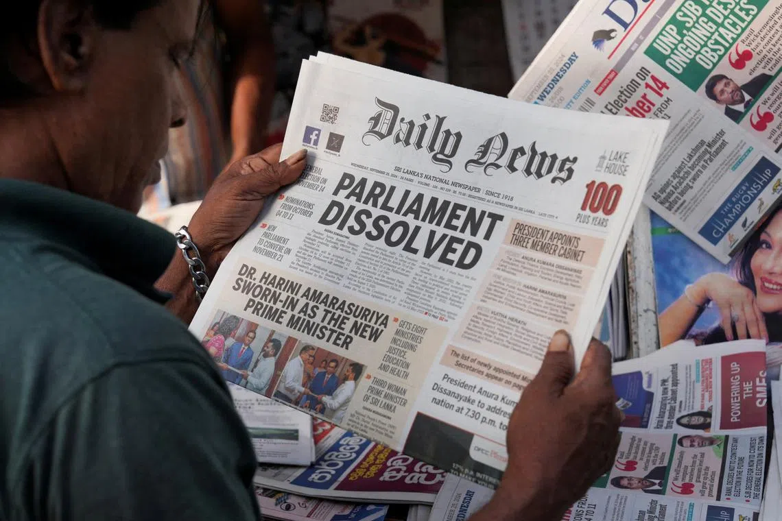 A person reads a newspaper following the appointment of Harini Amarasuriya as the new Prime Minister of Sri Lanka at a stall in Colombo, Sri Lanka, September 25, 2024. REUTERS/Thilina Kaluthotage/File Photo