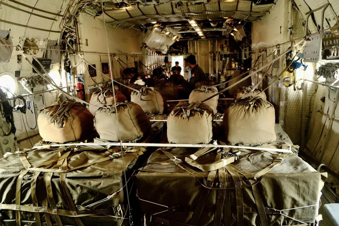 Pre-flight checks on the loads completed and ready to be airdropped.