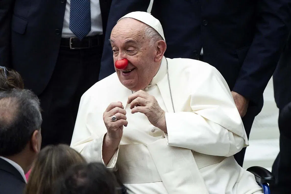 epa11557645 Pope Francis wears a red nose during the weekly general audience in the Paul VI Hall, Vatican City, 21 August 2024. EPA-EFE/ANGELO CARCONI
